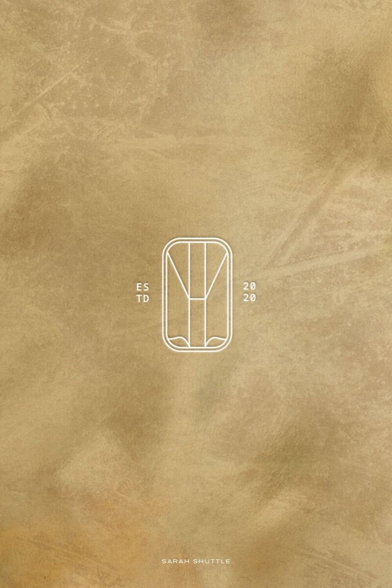 Modern Lucent emblem displayed on a hand-painted background, emphasising the artistic and contemporary brand style.