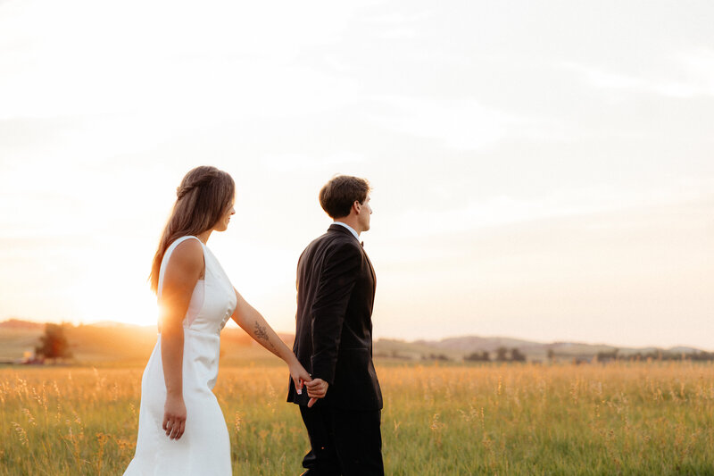 A couple standing in front of a beautiful landscape.