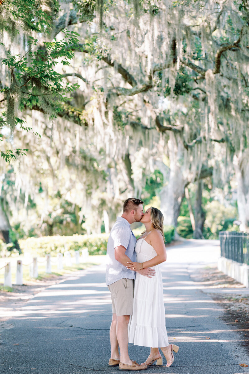 Isle of Hope, this engagement session is a dreamy blend of romance and coastal charm. As a Georgia wedding photographer, I love showcasing the enchanting backdrop of this idyllic location, where oak trees draped in Spanish moss frame every tender moment