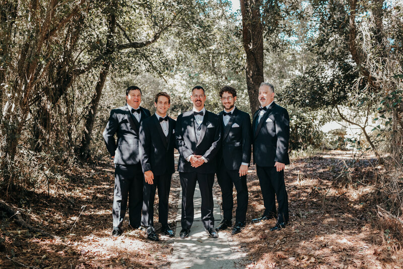 Groom with groomsmen in a forest setting