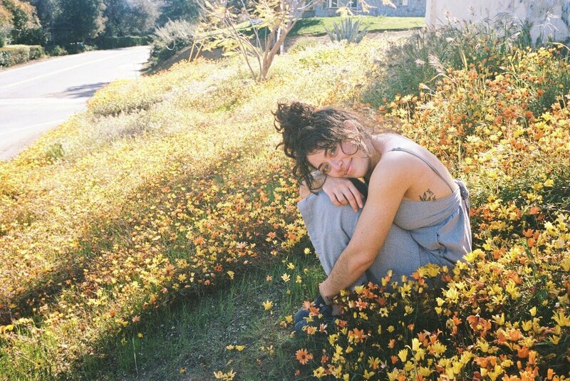 Casual outdoor moment of photographer in Puerto Rico among wildflowers

