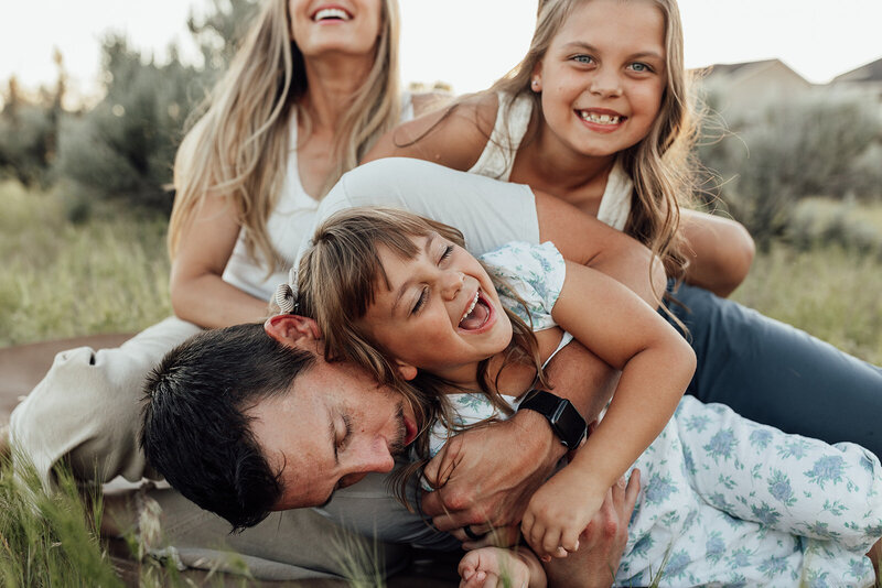 Candid family photo with mom, dad, and two young girls