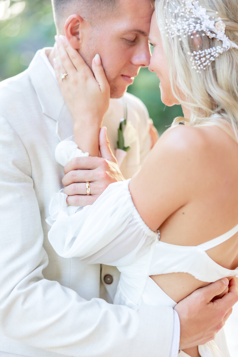 Bride and groom sharing a quiet, emotional moment during golden hour — a close embrace capturing love and tenderness.