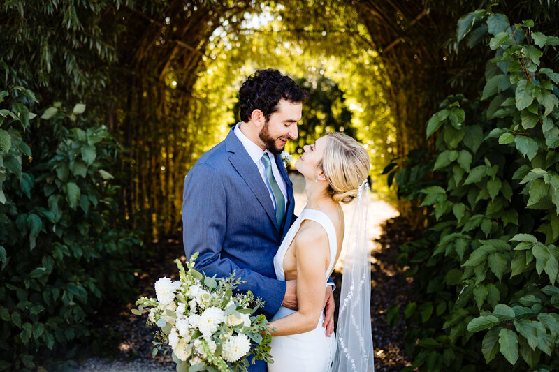 Wedding couple embracing in a garden in Ann Arbor Michigan during the summer