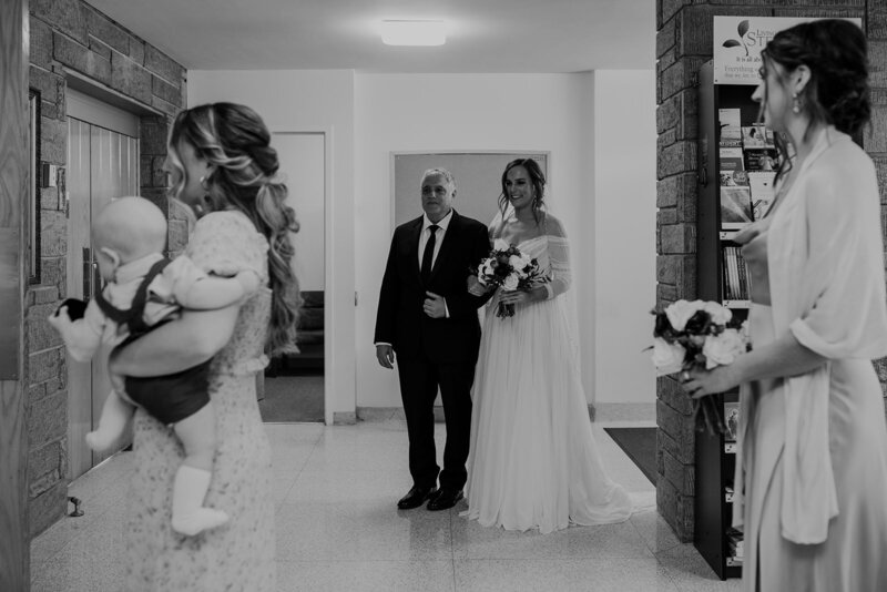 Wedding party and a newlywed getting ready to walk down the aisle
