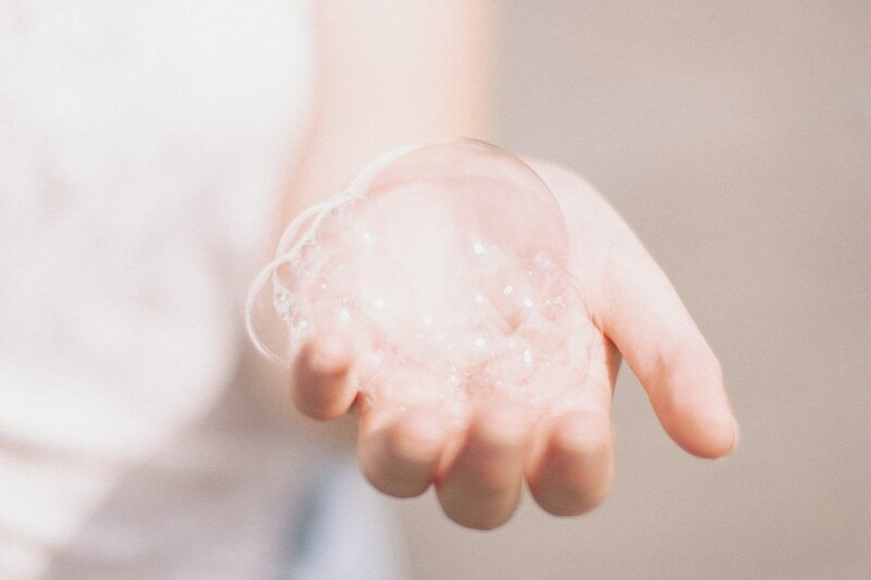 Cupped hand with soapy bubbles
