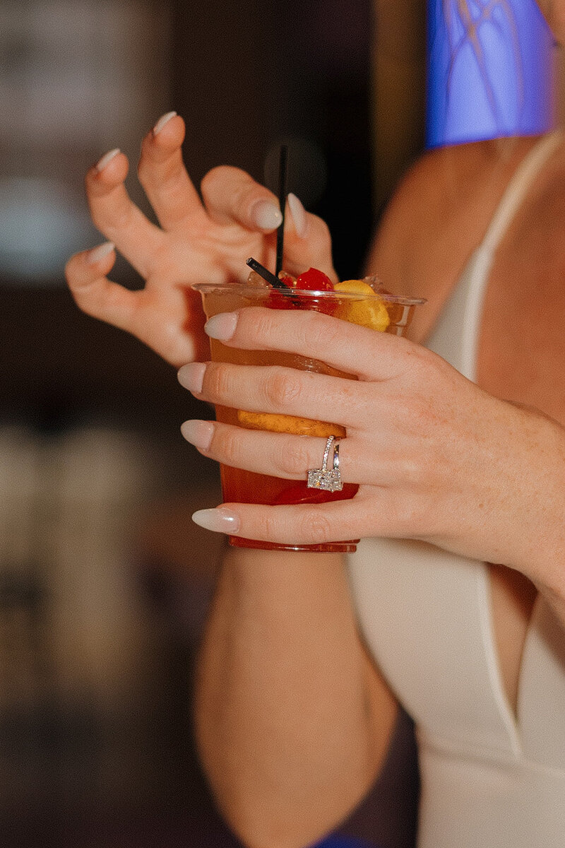 The bride celebrates with her signature drink, a wisconsin old fashioned at the valerie wedding venue in oconomowoc, wisconsin 