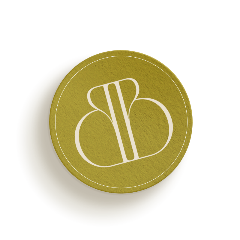 A round, greenish-gold token with a stylized white symbol resembling an abstract butterfly or B shape in the center, perfect for adding a touch of elegance to your small business website design services.