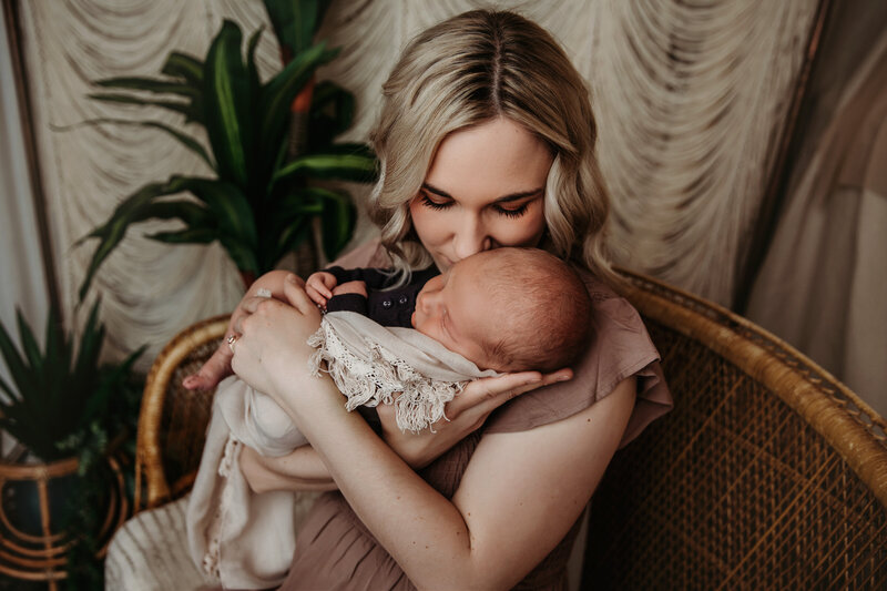 Newborn laying ont an blanket with eyes open