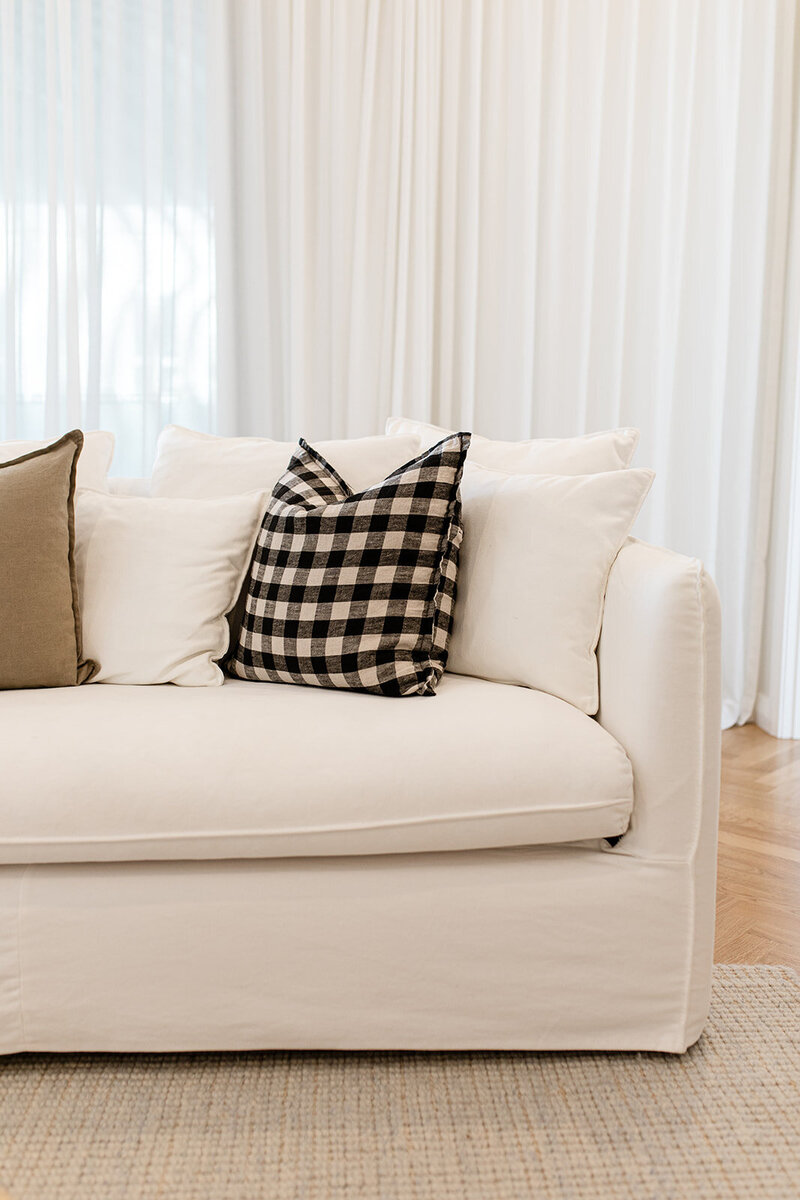 White lounge with black and white checkered cushion