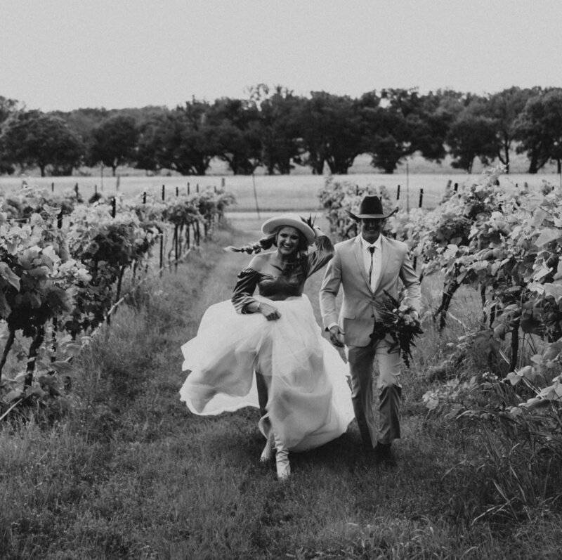 couples skipping through the vineyard at florence