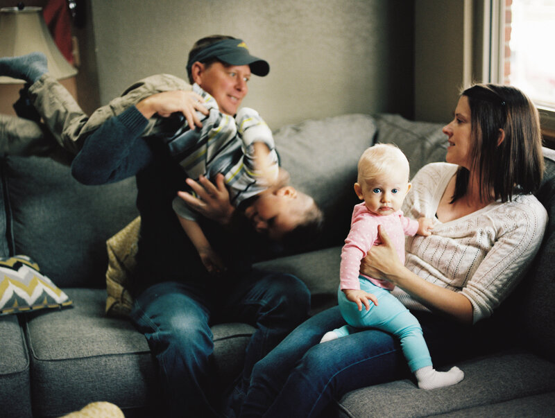 a family plays or chills on a colorado couch