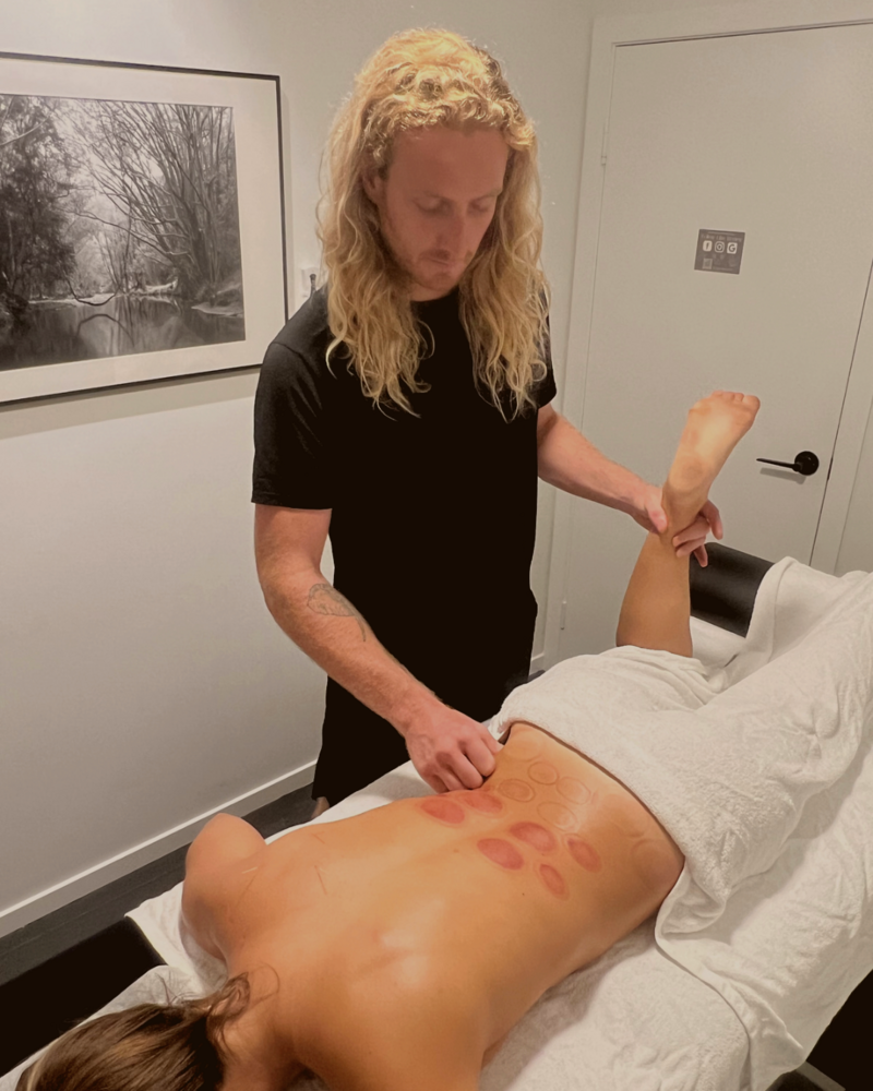 male myotherapist treating back with trigger point therapy