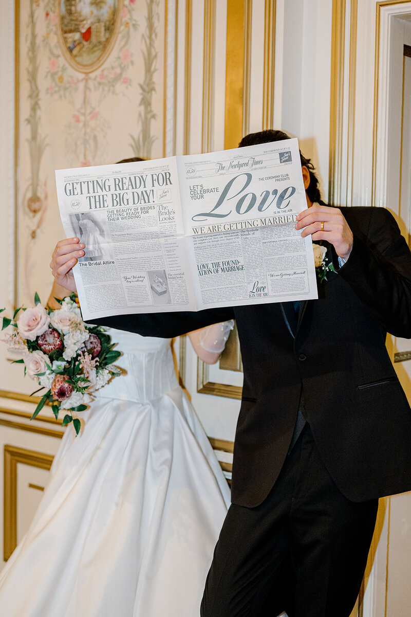 bride and groom reading wedding newspaper