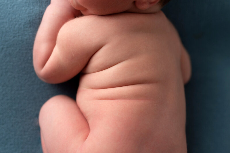 Newborn baby rolls photographed during newborn session.