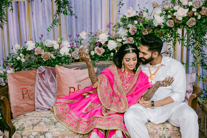 indian couple in pink and white cultural attire smiling