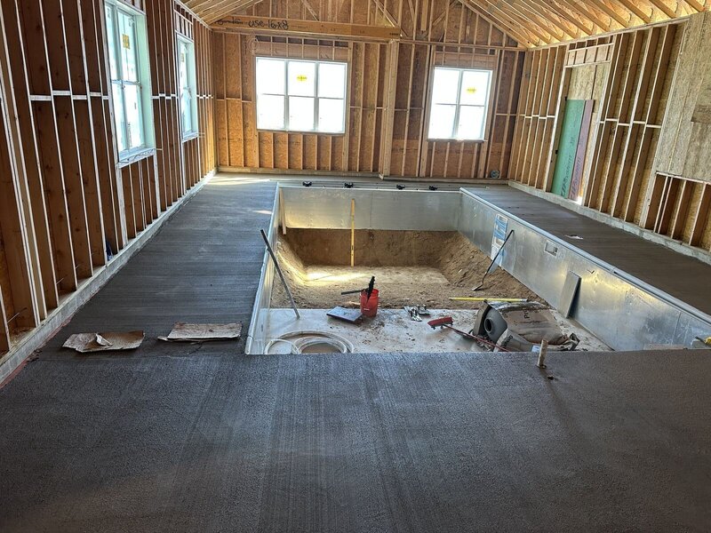 Concrete deck poured around an indoor pool inside a new building