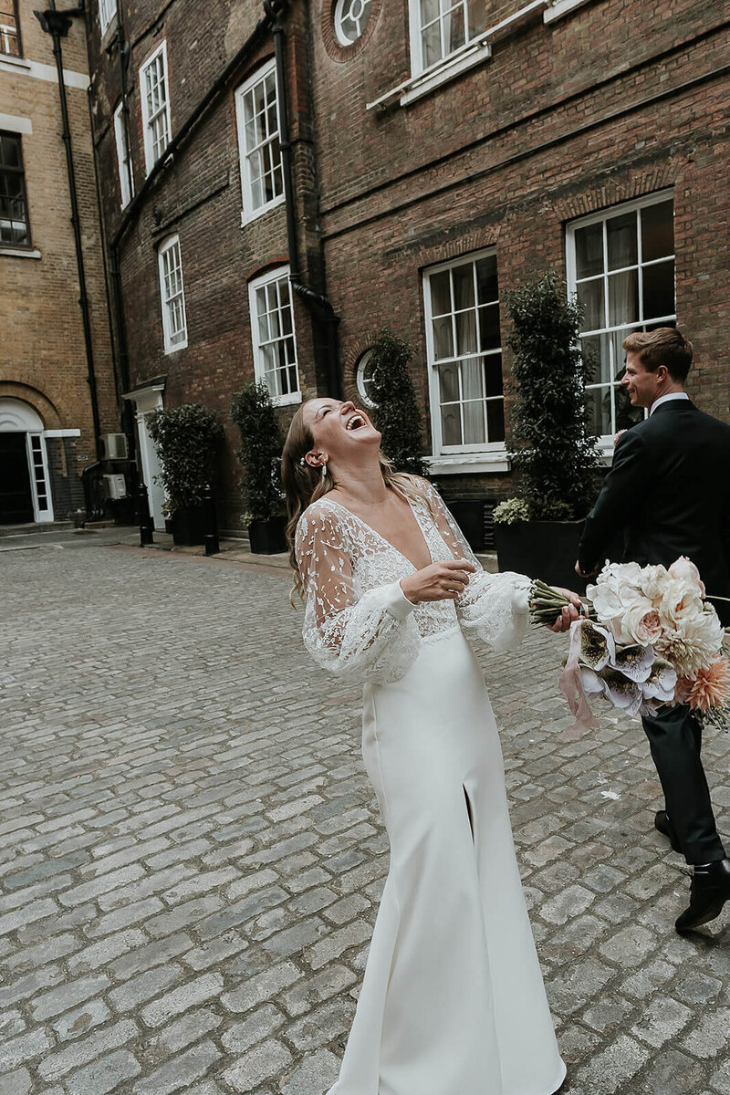 Bride laughing outside Truman Brewery London
