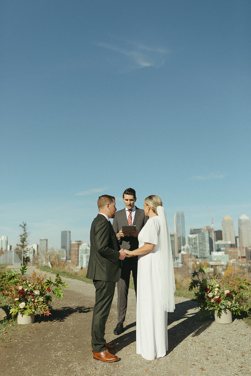 bride and groom at ceremony overlooking Calgary