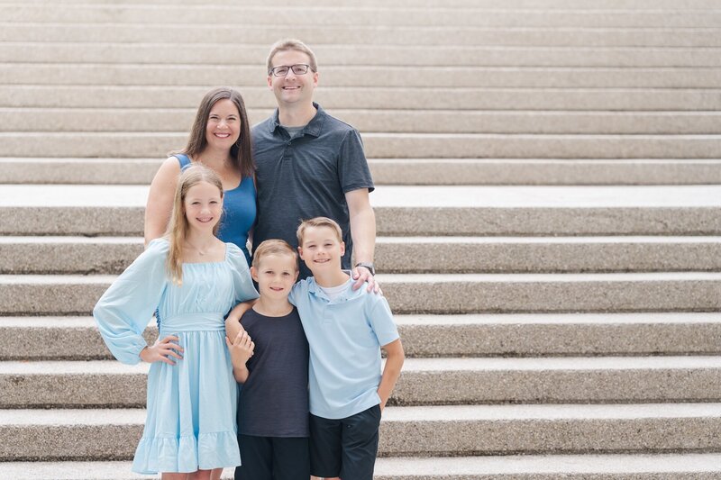 two teachers posing with their 3 kids