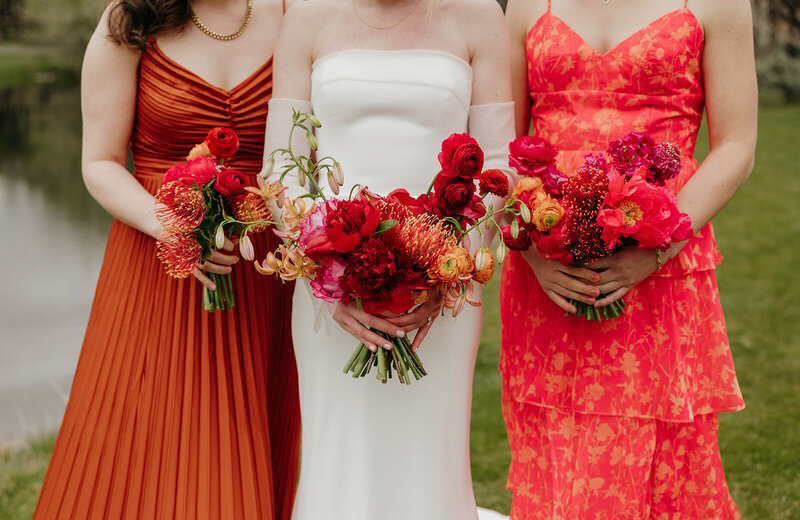 Spring wedding bouquet with protea, lilies, and garden roses