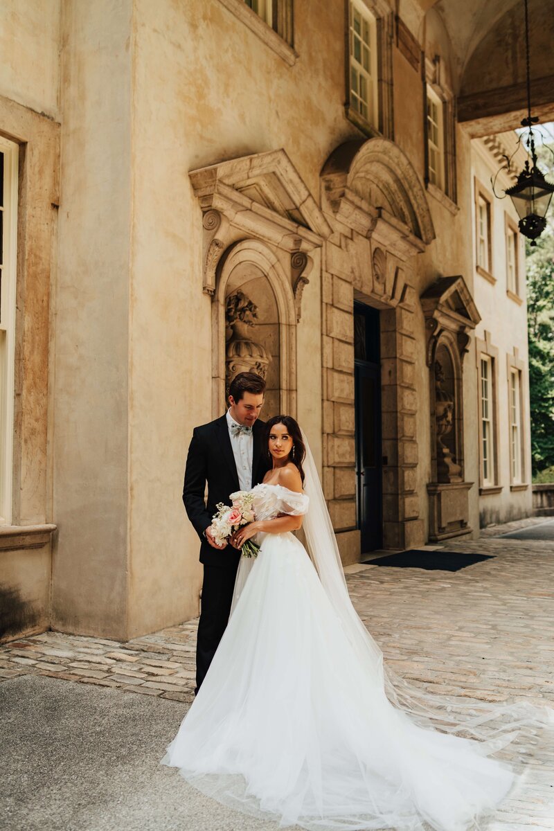 Bride and groom in front of an Italian architectural building in Atlanta at The Swan House