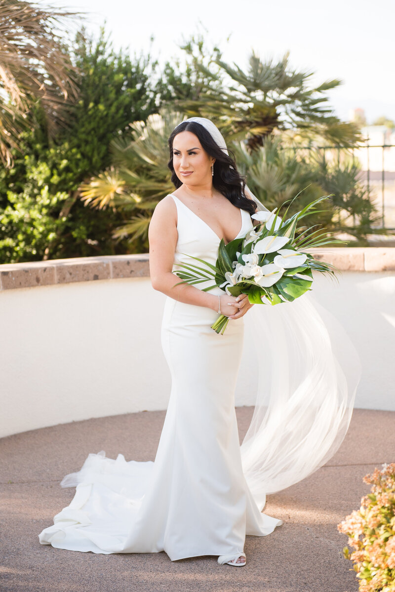 Bride posing in ‘The Archie’ gown from Love and Lace Bridal Salon at Emerald at Queensridge with soft natural light highlighting her modern bridal look.