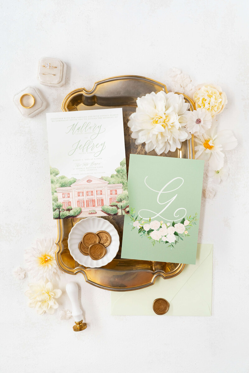 custom sage green wedding invitations featuring a white floral wreath crest, perfect for a Tate House wedding in North Georgia