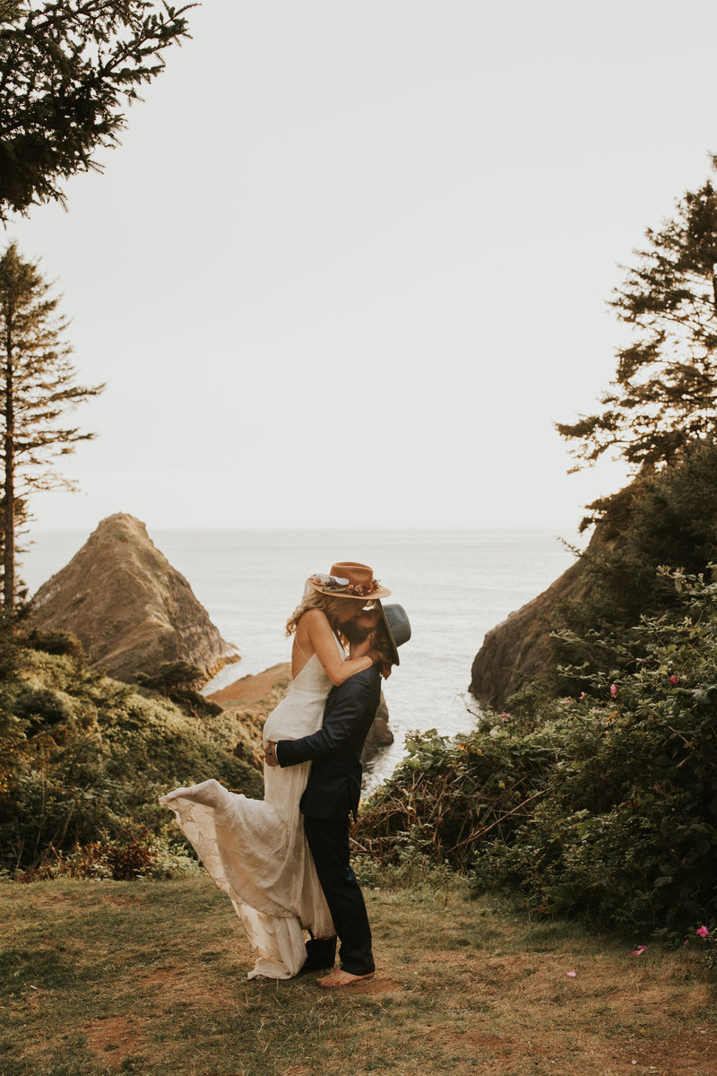 Happy couple have their elopement photos taken on the Oregon Coast