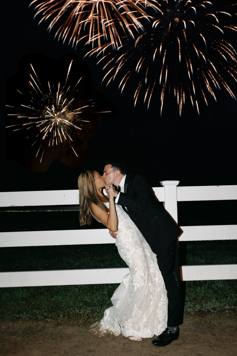 Bride groom with fireworks in the background at their backyard wedding
