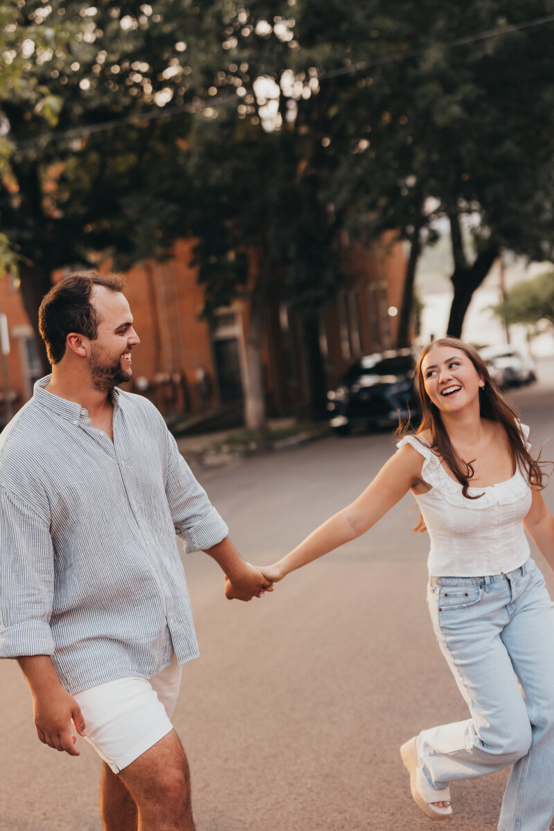 Golden hour family session with parents holding todder in the air