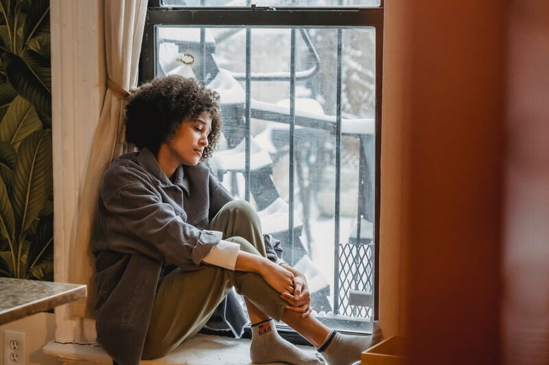 a woman looking out of her window