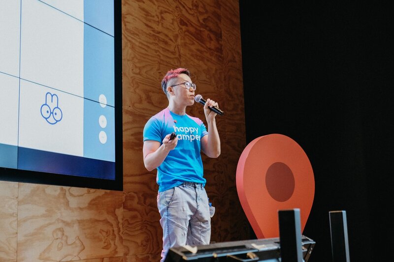 Dan speaking at Google in a Happy Camper tee