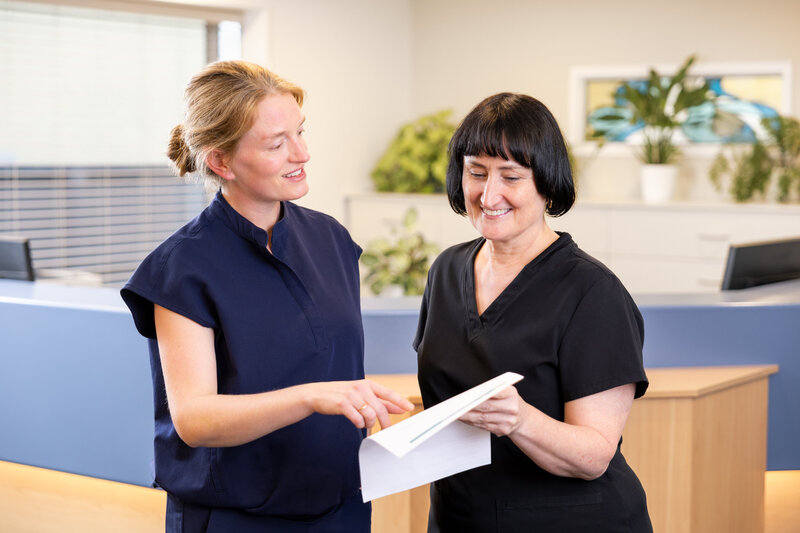 Two dentists discussing patient treatment plan