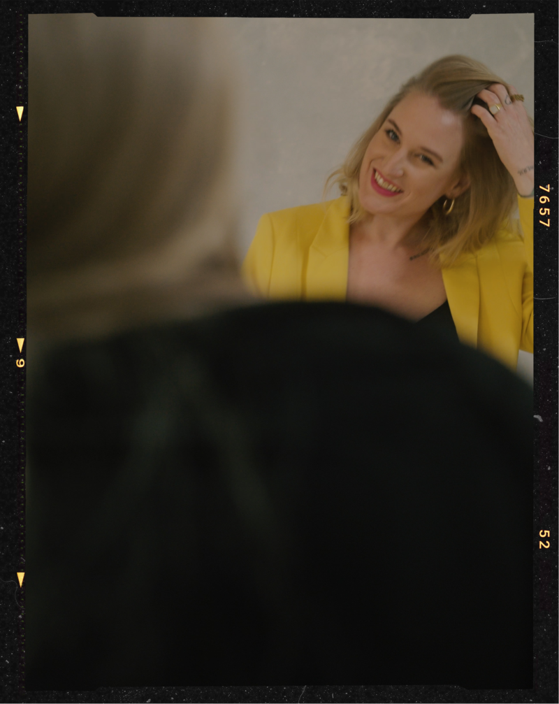 Behind the scenes photo of an empowering portrait session of a woman in a yellow suit in Helena Kristianssons Stockholm Studio