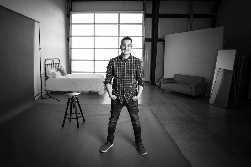 Christopher Reynolds, founder of Art of You Portrait Studios, standing in a photography studio.