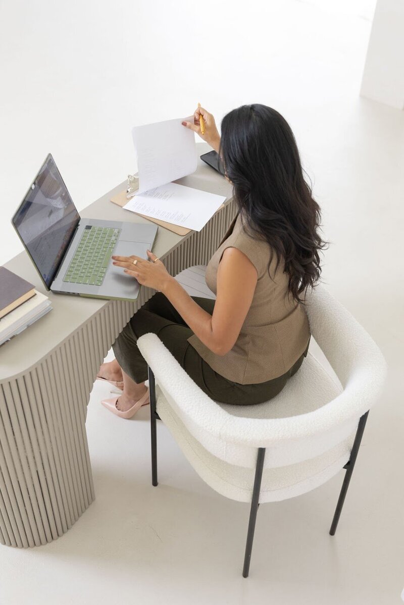 Female event planner sitting at desk