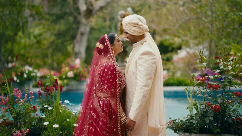 Indian wedding couple posing at the garden