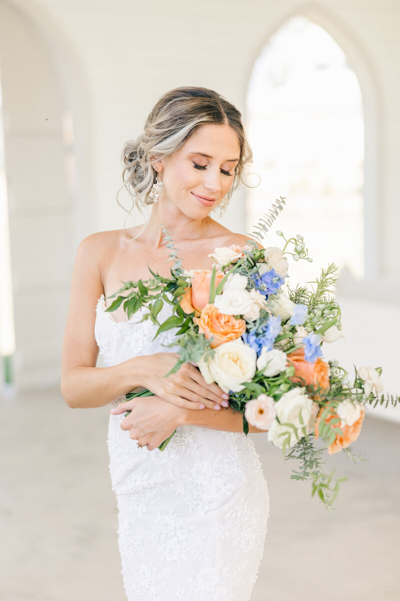 bride gazing at her bouquet