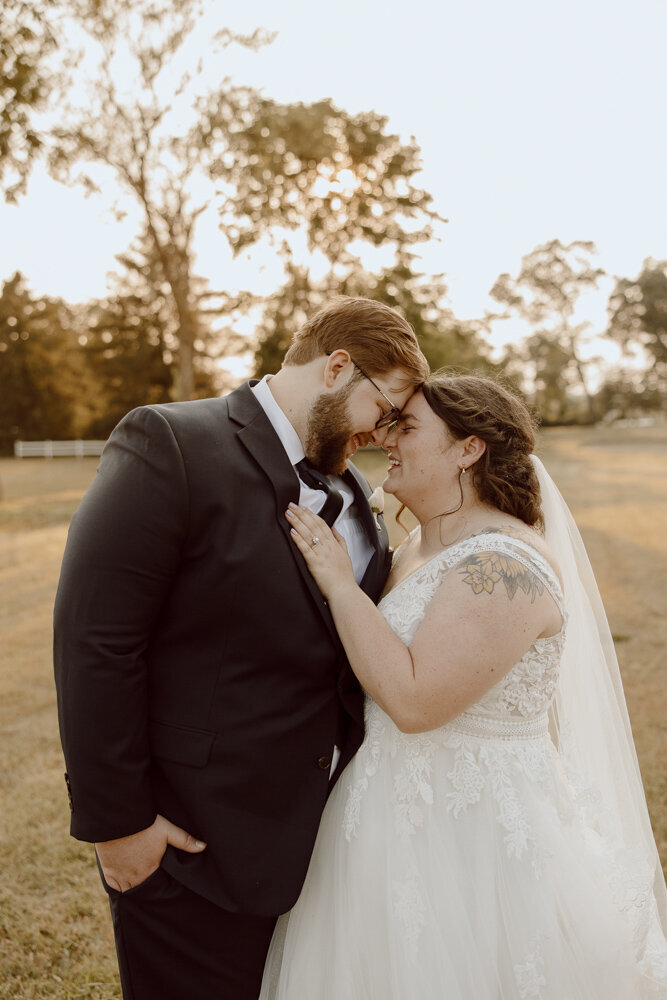 During their Denton, Maryland wedding, a bride and groom face each other and smile after wedding ceremony.