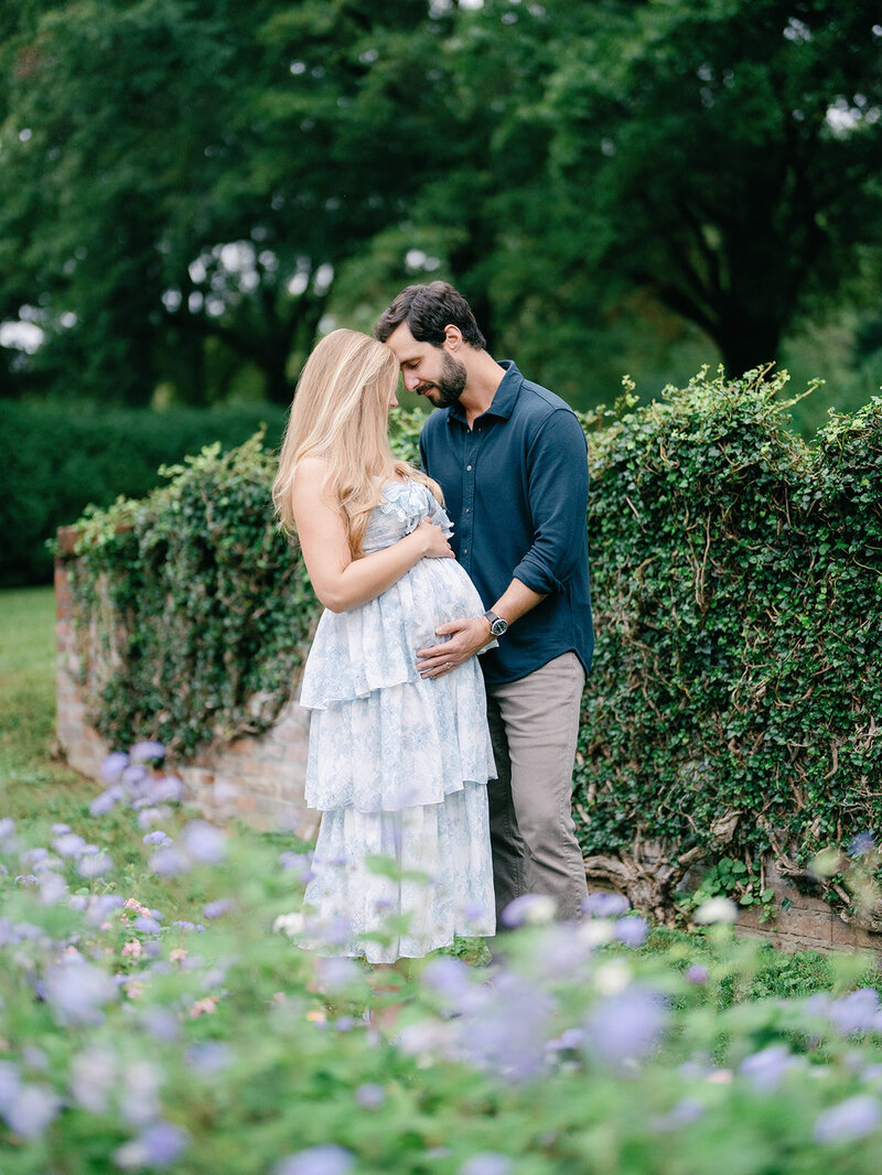 Couple shares a sweet moment in an english garden setting