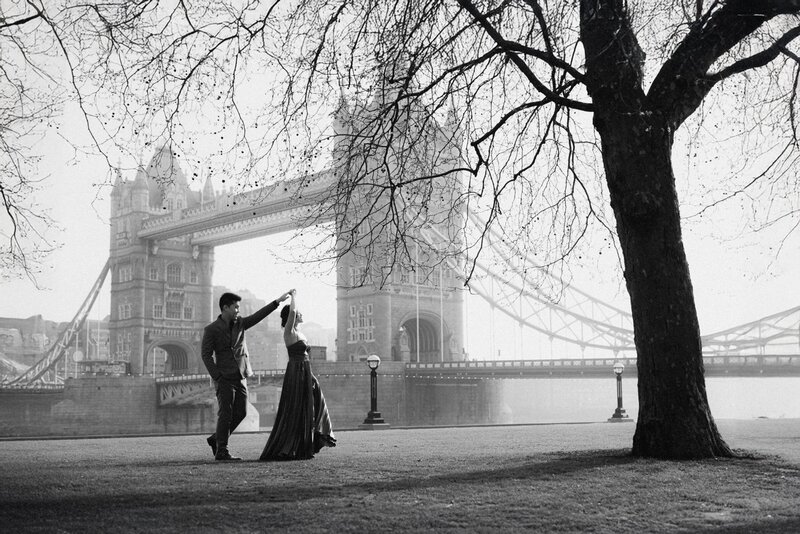 Couple in alternative wedding dress dancing with iconic Tower Bridge in the background