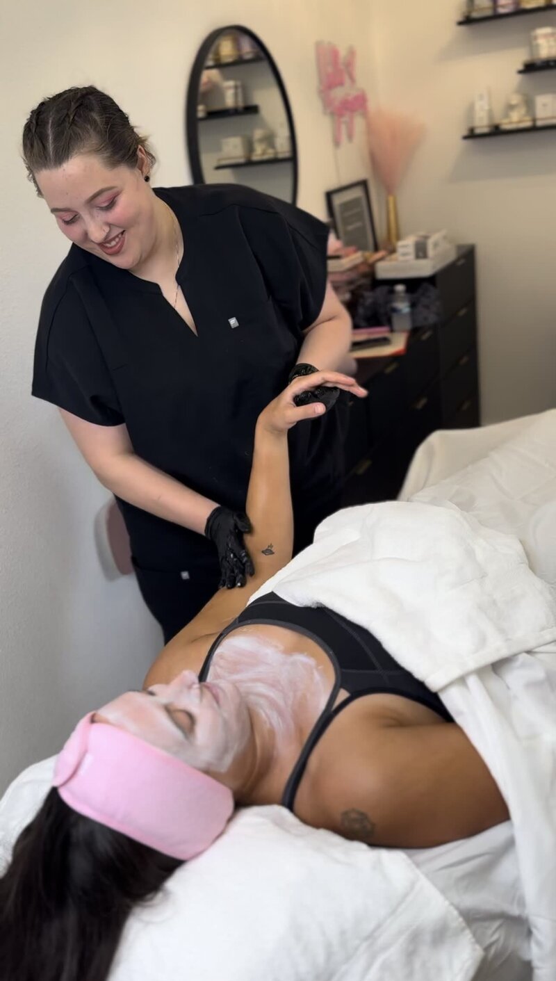 Esthetician giving client hand massage