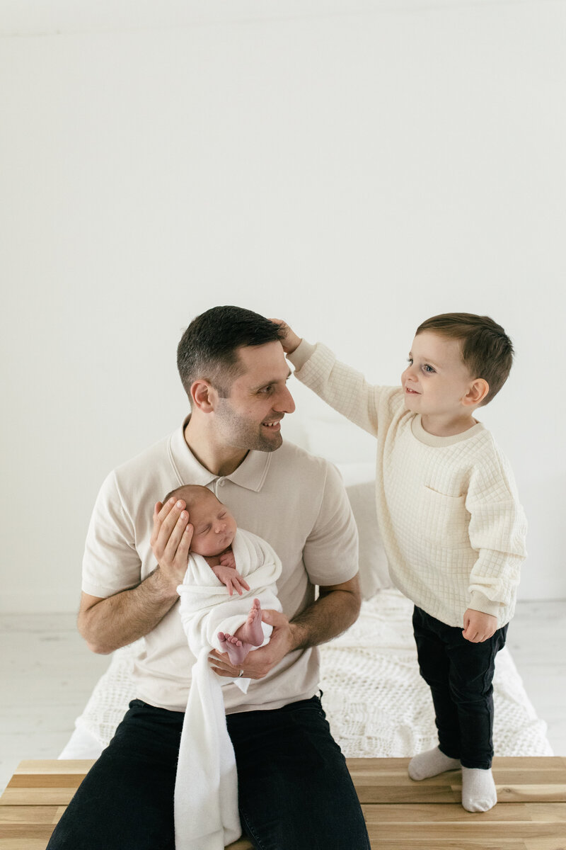 dad and son and newborn baby sibling shoot