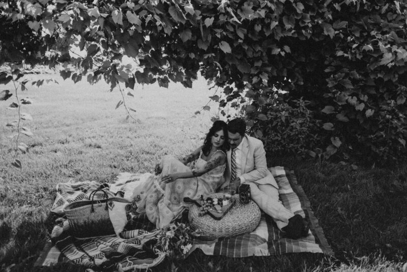 black and white photo of couple having picnic
