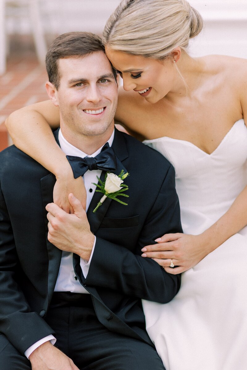Bride embraces her groom as he smiles
