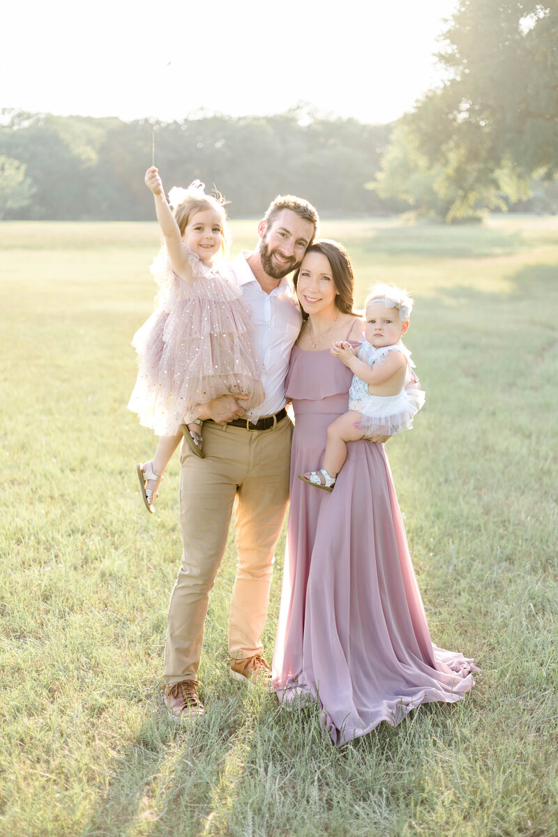 family posing in a field in Denton, TX