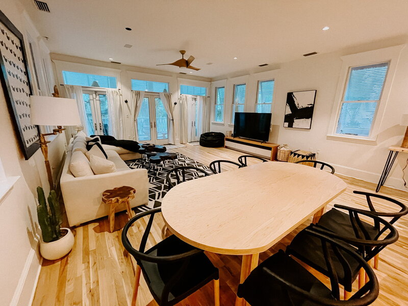 modern dining room with white table and black chairs