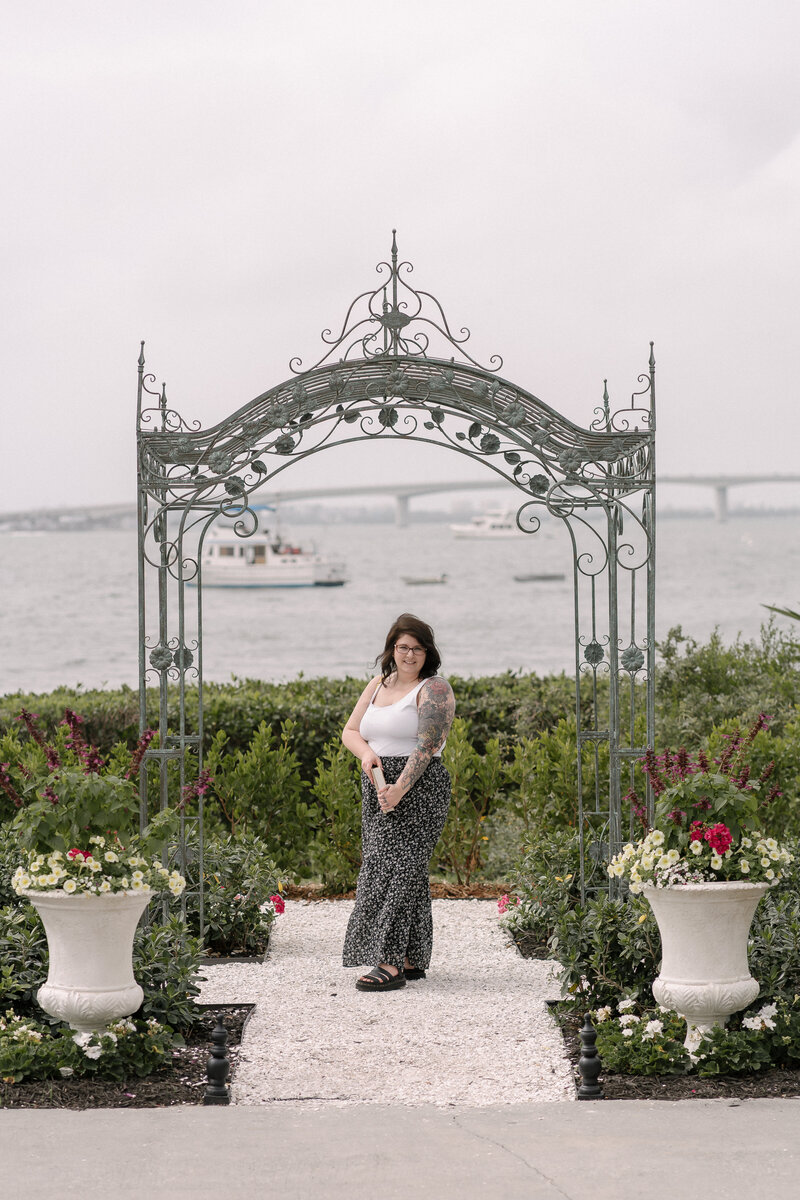 wedding photographer under arch at wedding venue 