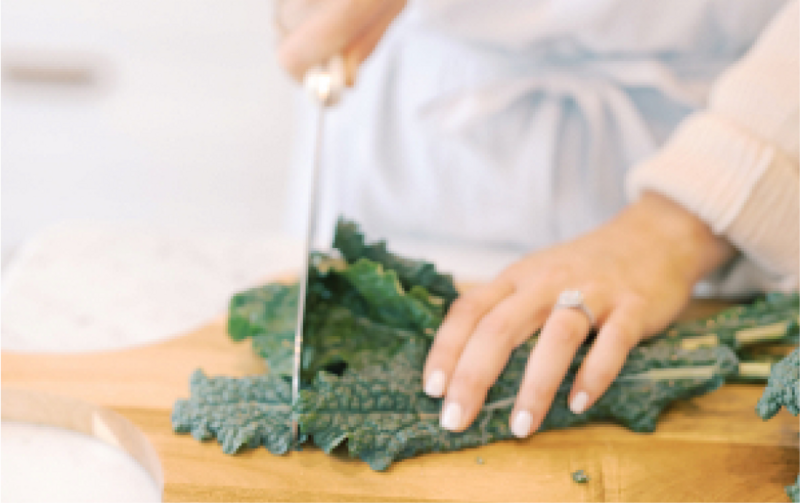 Female chopping kale